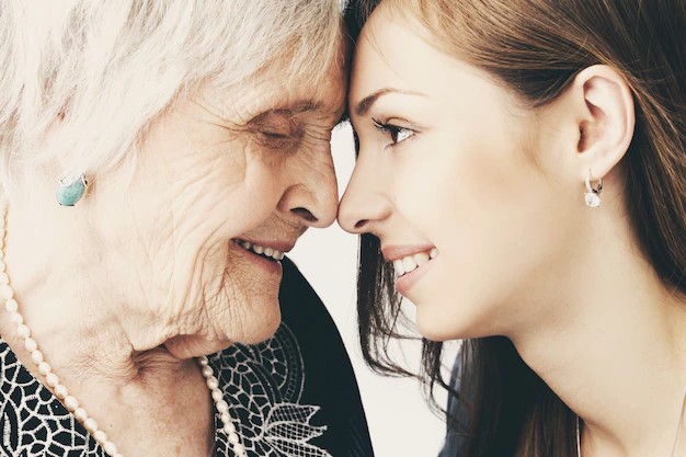 2 people touching noses to show a representation of being happy about old age