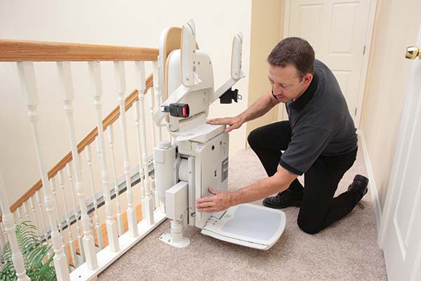 technician servicing stair lift 